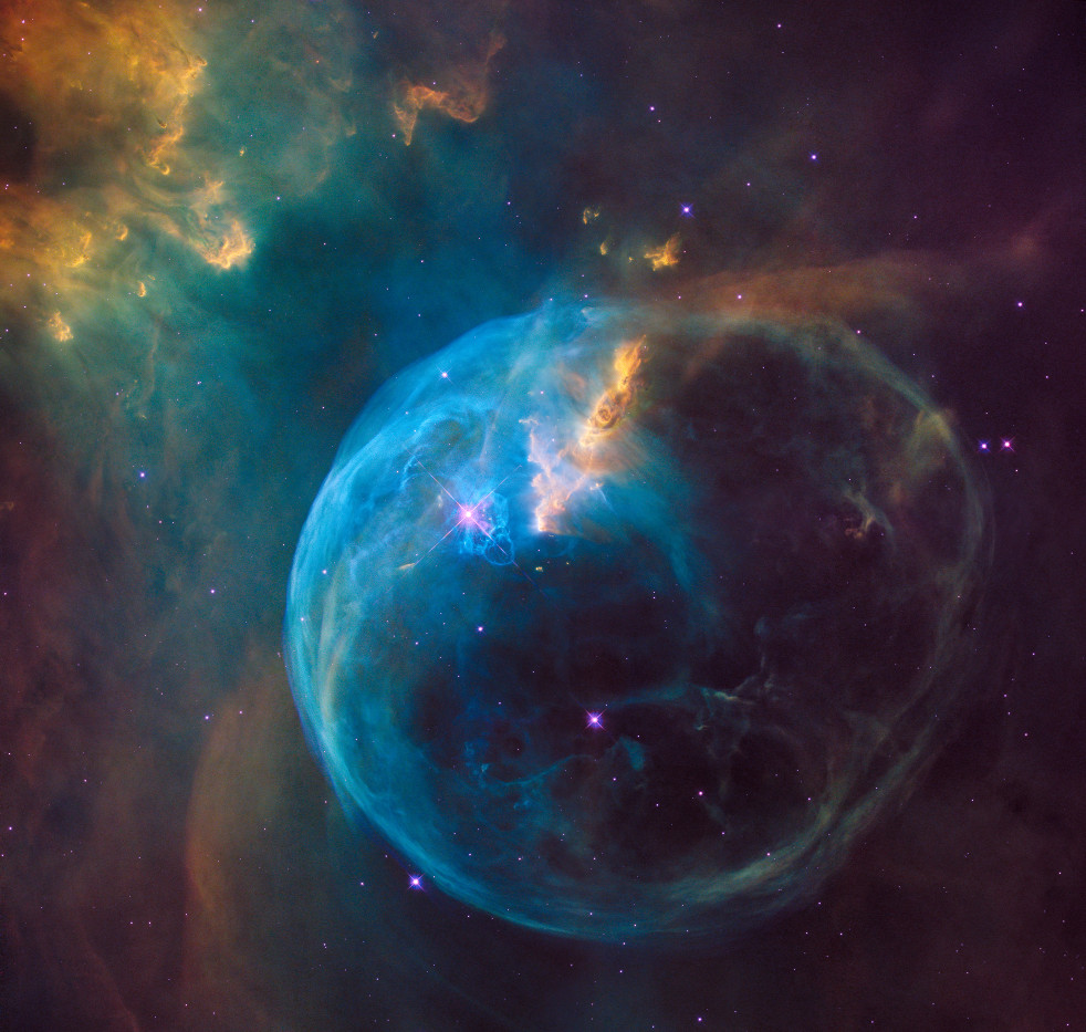 A blue spherical nebula glowing against the darkness of space.