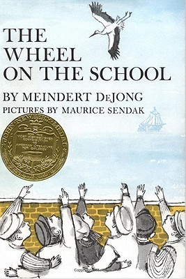 Cover of Meindert deJong's "The Wheel on the School" featuring a watercolor illustration by Maurice Sendak of five young boys and one girl in traditional Dutch clothing standing in front of a yellow wall, pointing and looking at a stork flying against a clear blue sky.