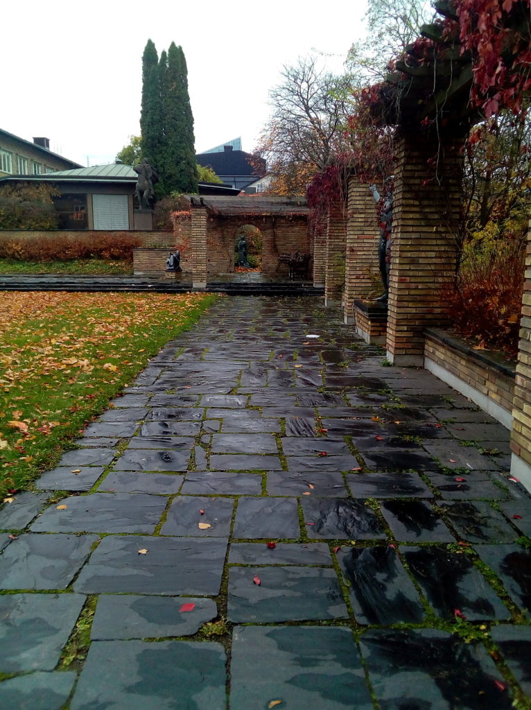 A slate walkway and some statuary at Marabouparken on a rainy, overcast day.